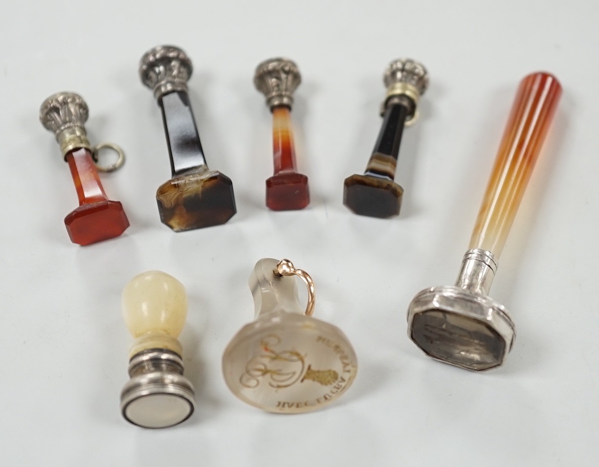 Five assorted 19th century white metal mounted agate seals, largest 61mm, a similar white metal and mother of pearl mounted seal and a white chalcedony seal with monogrammed matrix.